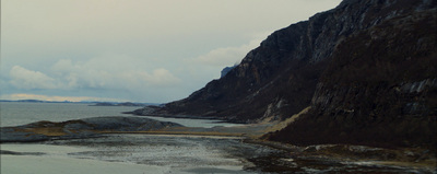 a view of a body of water with a mountain in the background