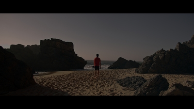 a man standing on top of a sandy beach