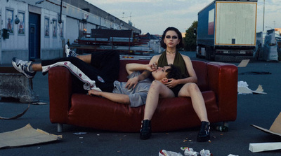 a couple of people sitting on a red couch