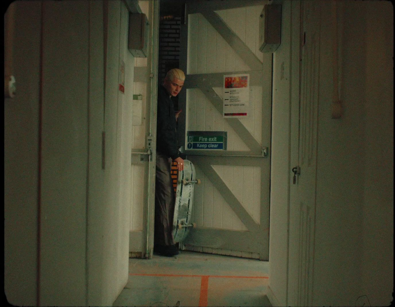 a man standing in a doorway with a suitcase