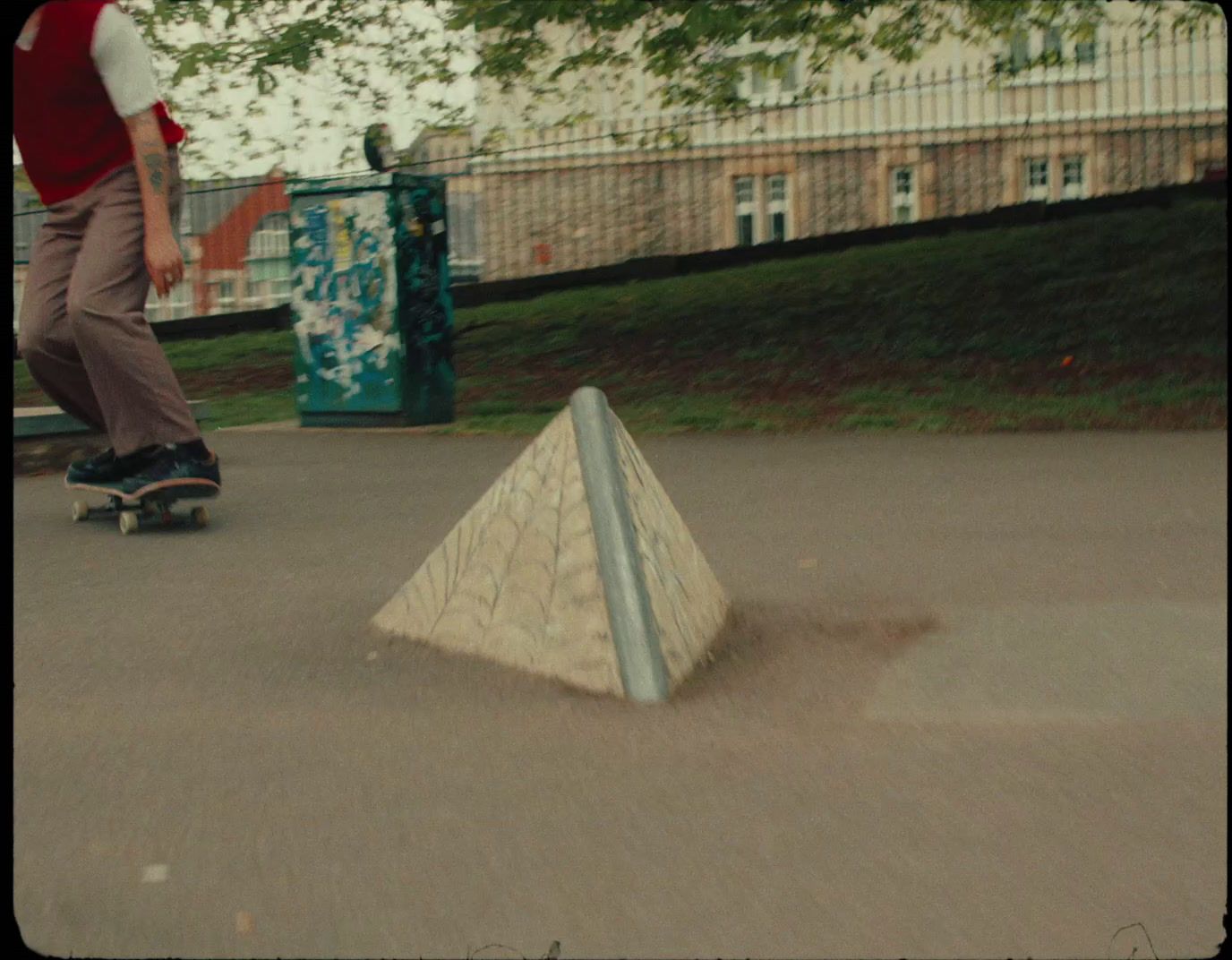 a man riding a skateboard down a sidewalk