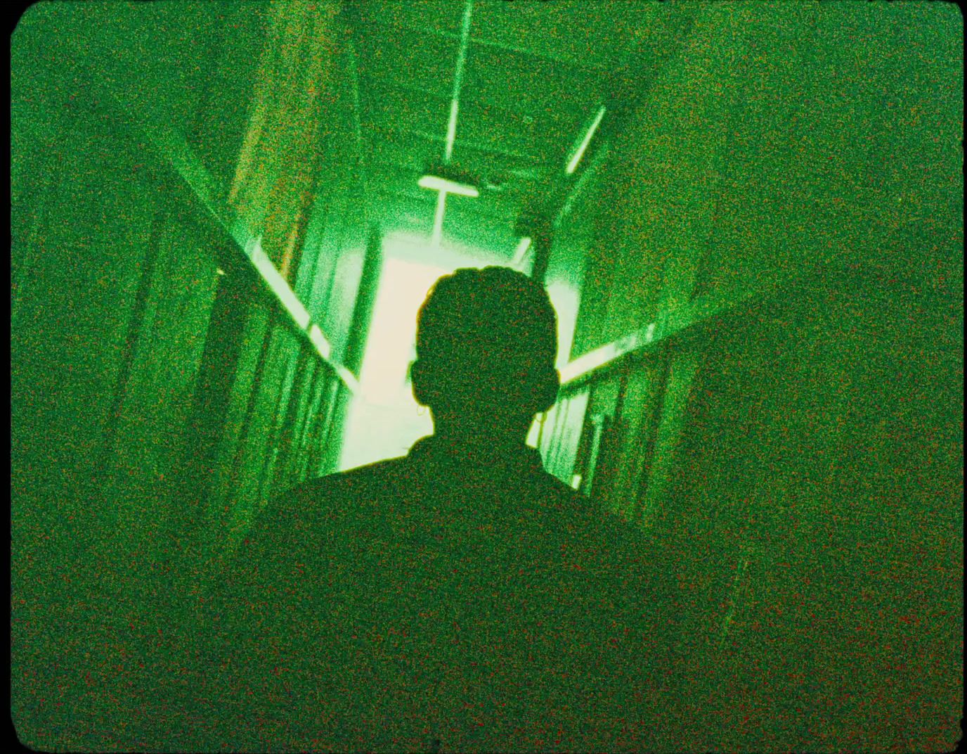 a man is standing in a dark hallway