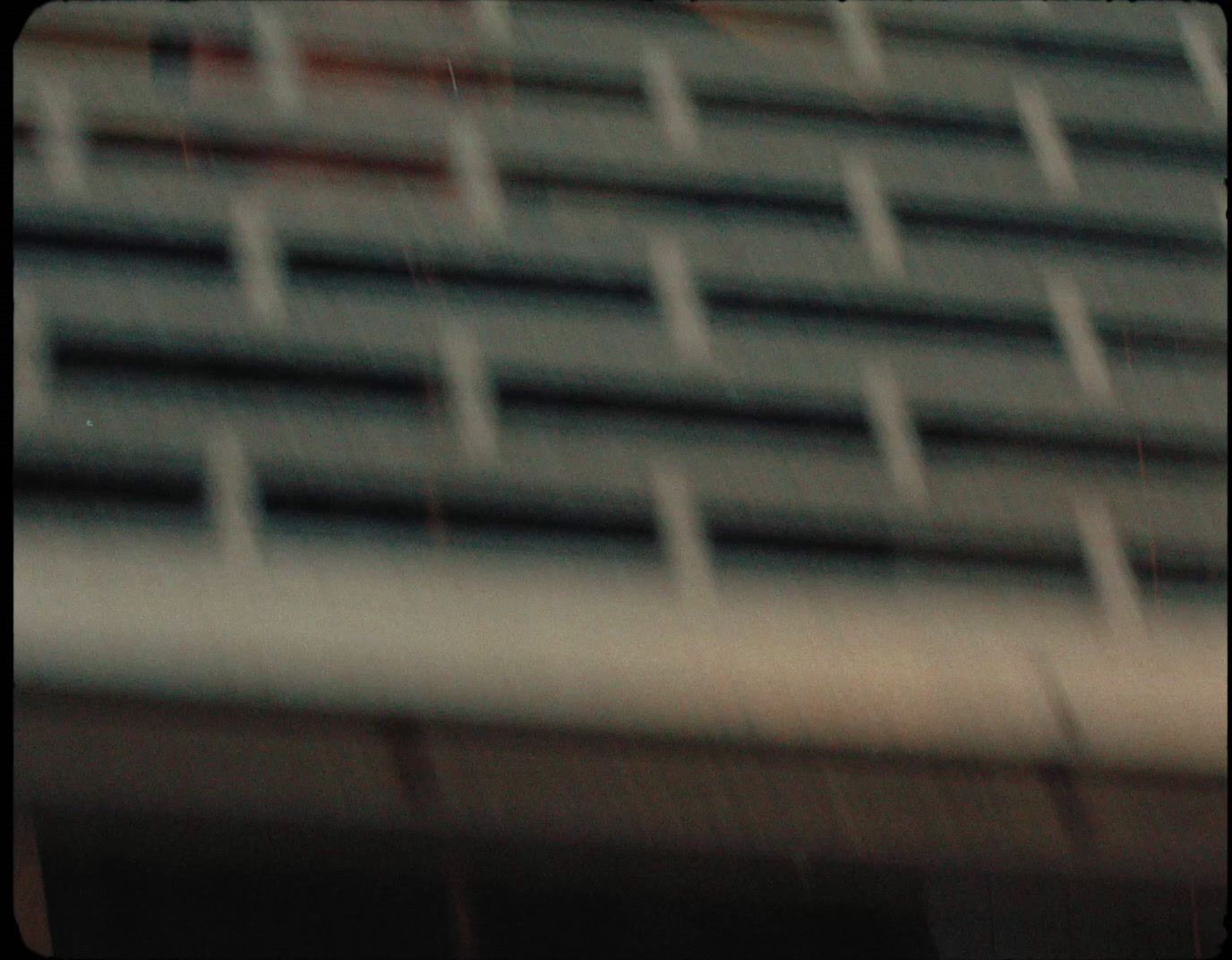 a red stop sign sitting in front of a tall building