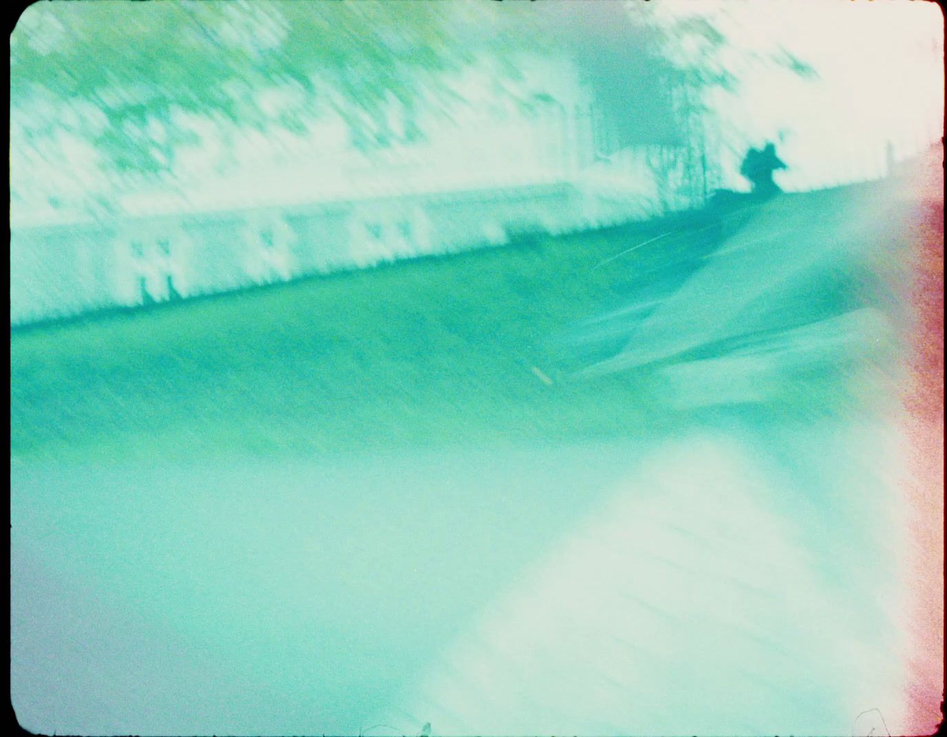 a blurry photo of a skateboarder doing a trick