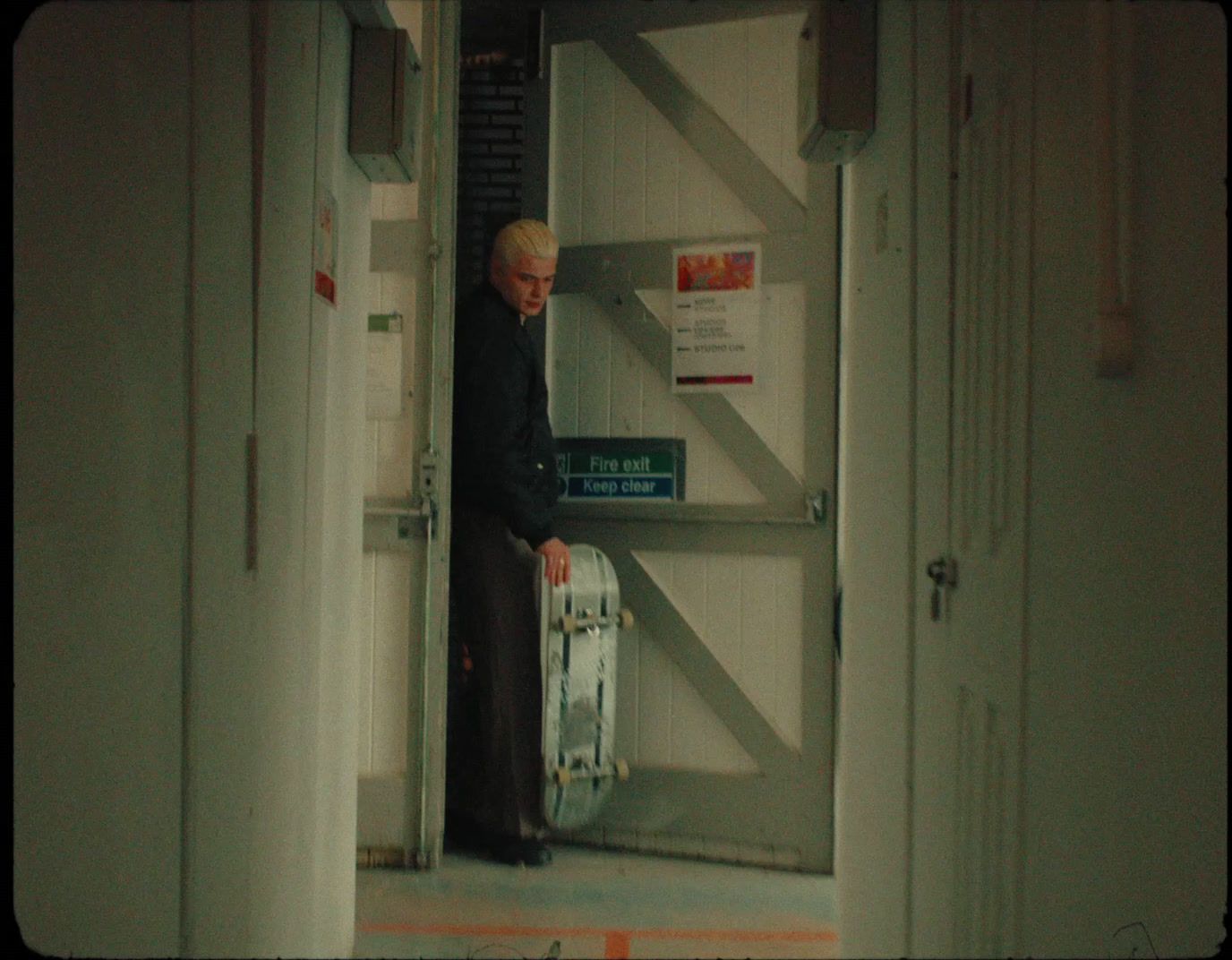 a man standing in a doorway with a suitcase