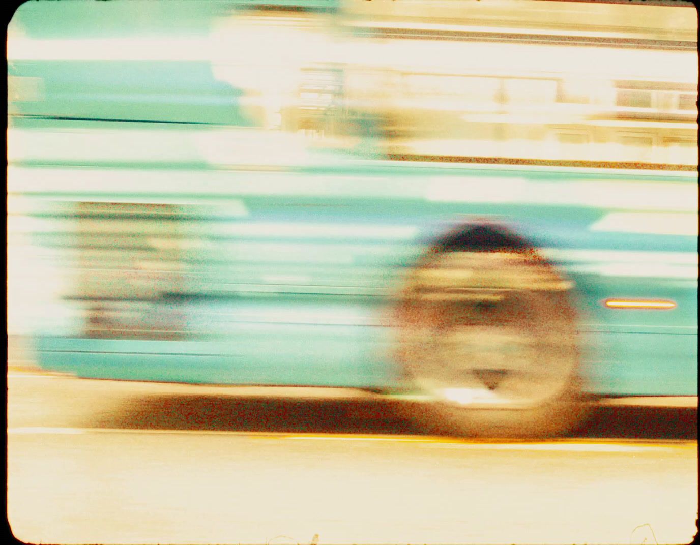 a blurry photo of a fire hydrant in front of a bus