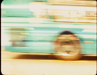 a blurry photo of a fire hydrant in front of a bus