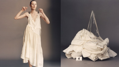 a woman standing next to a pile of cloth