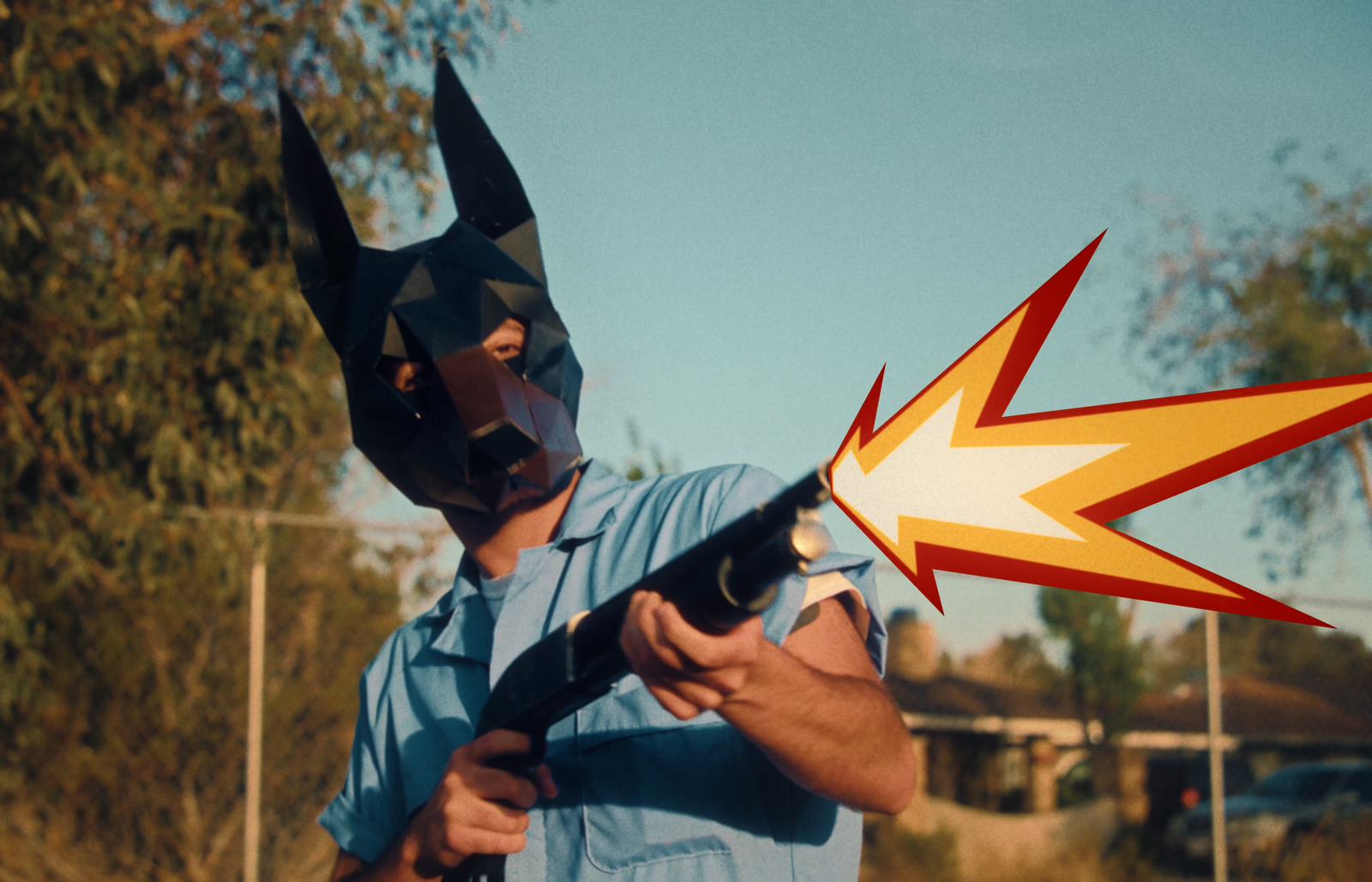 a man wearing a batman mask holding a gun