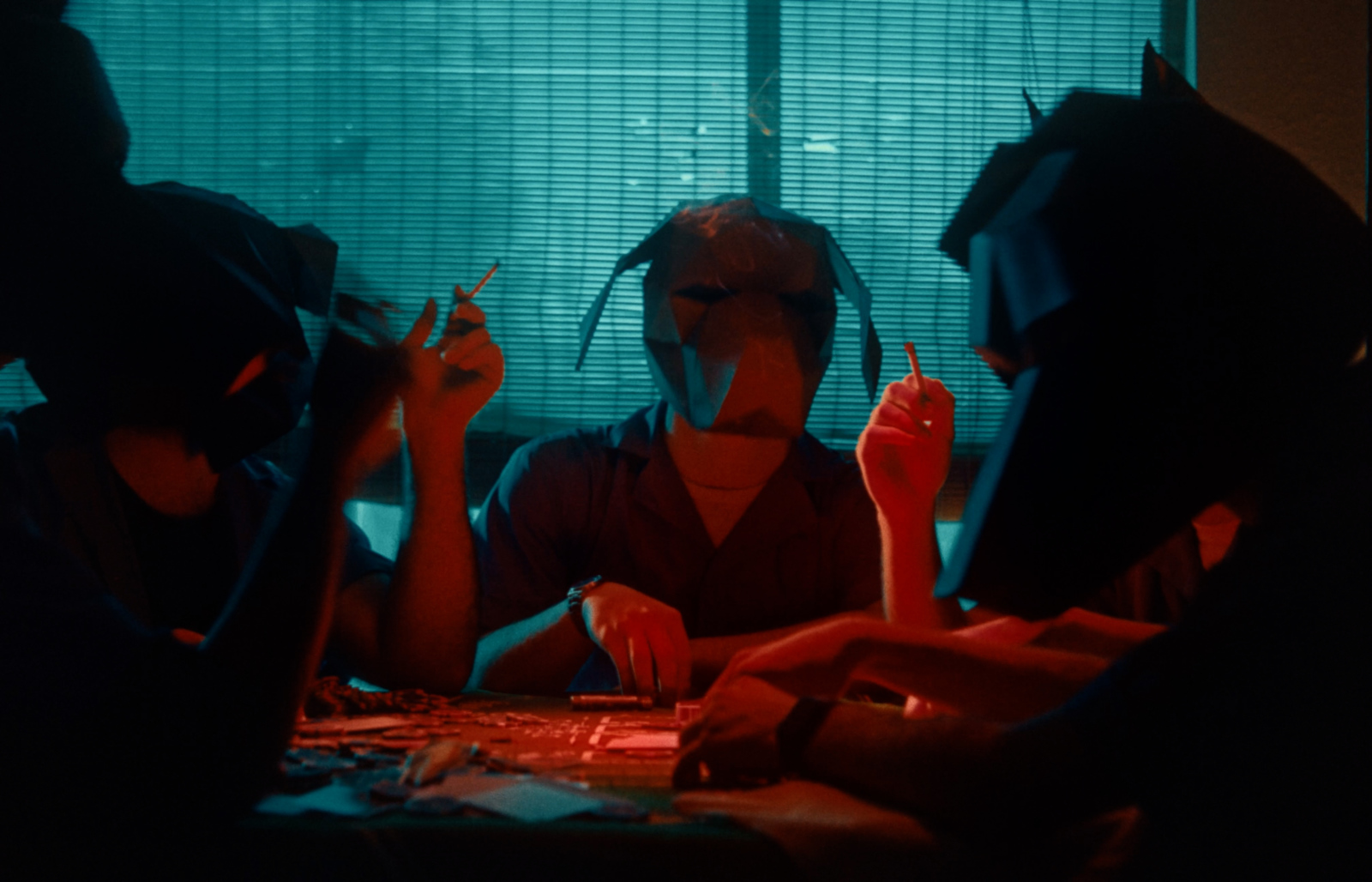 a group of people sitting around a table in front of a window