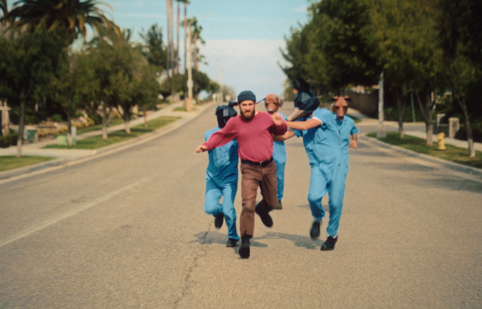 a group of men running down a street