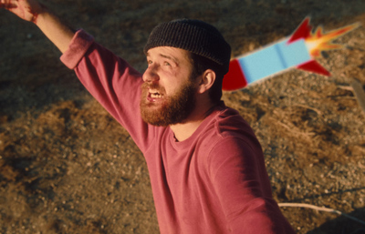 a man with a beard is holding a kite