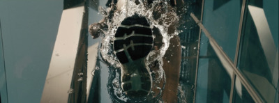 a person's feet are seen through a hole in a glass door