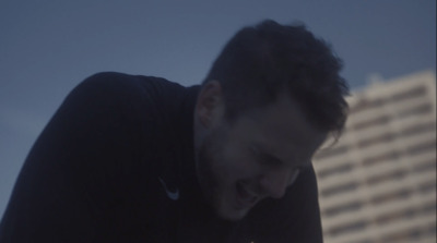 a man in a black shirt looking down at his cell phone