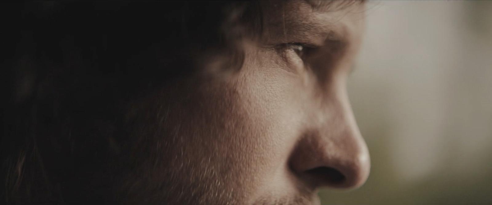 a close up of a man's face with a blurry background