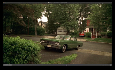 a green car parked on the side of the road