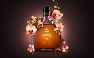 a bottle of crafter vs whiskey with orchids on a dark background