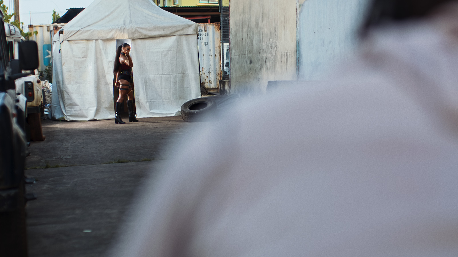 a woman standing in front of a white tent