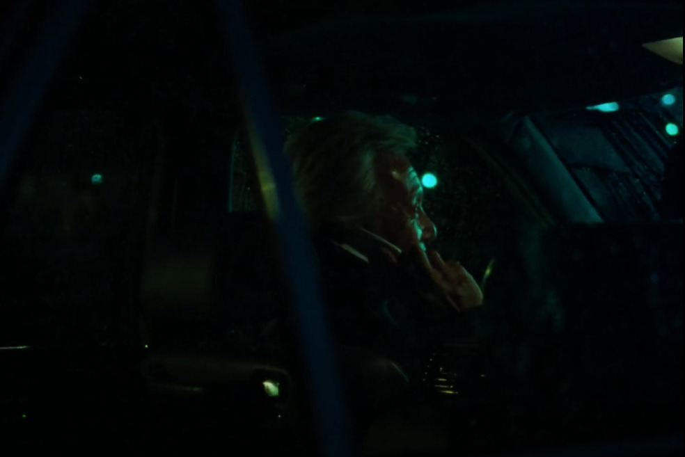 a woman sitting in a car talking on a cell phone