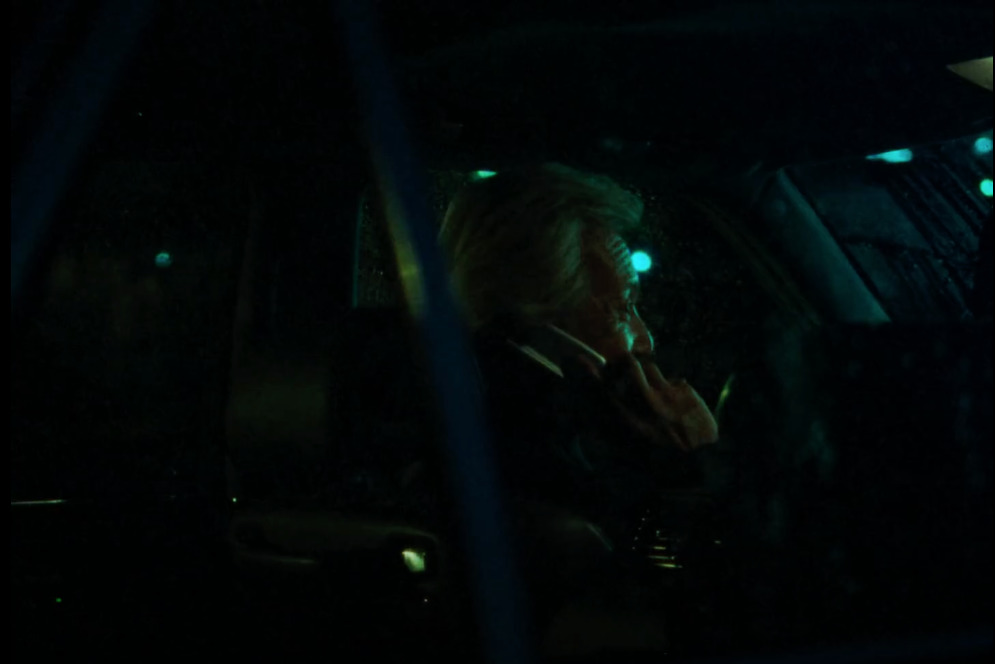 a woman sitting in a car talking on a cell phone