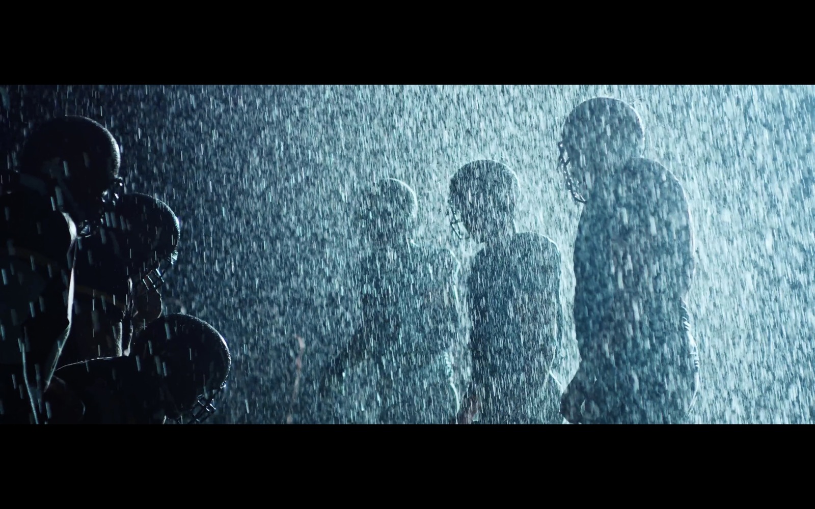 a group of people standing in the rain