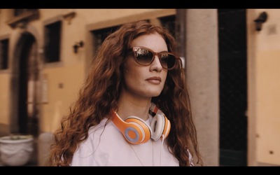 a woman with long red hair wearing headphones