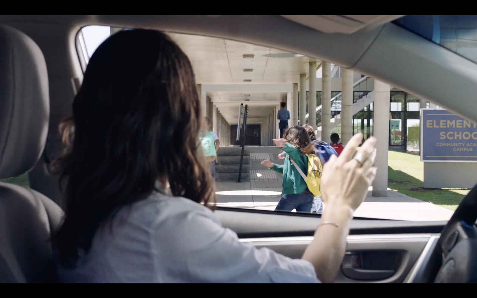 a woman driving a car while holding a cell phone