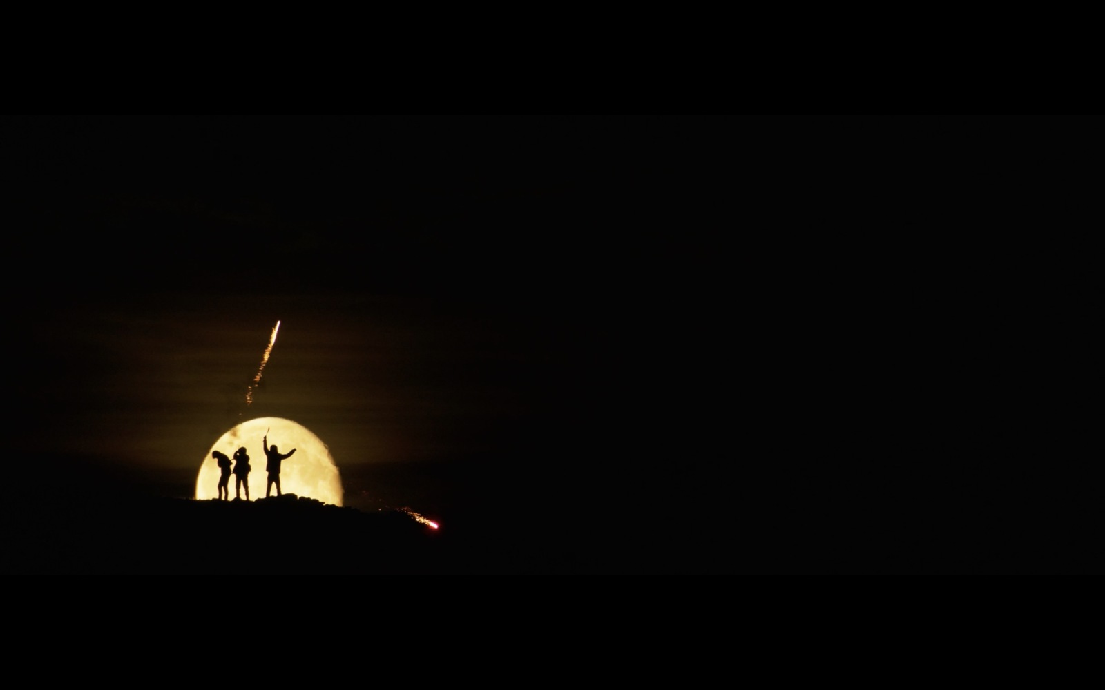 a group of people standing on top of a hill