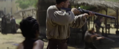 a man holding a gun while standing next to a woman