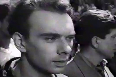 a black and white photo of a man in a crowd