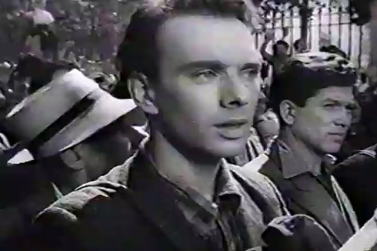 a black and white photo of a man in a crowd