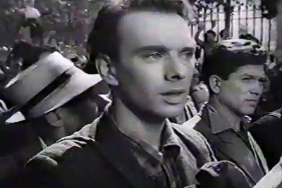 a black and white photo of a man in a crowd