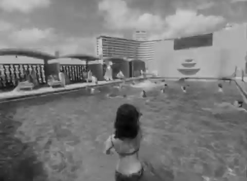 a woman in a bikini standing in a swimming pool