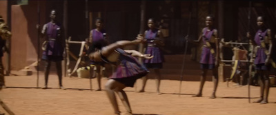 a man playing tennis in front of a group of men