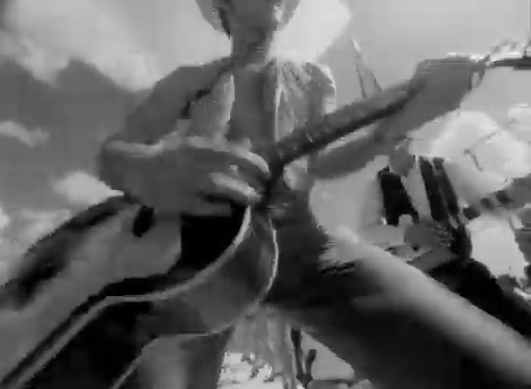 a black and white photo of a man playing a guitar