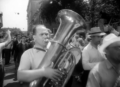 a black and white photo of a man playing a trumpet