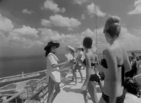 a group of people standing on top of a boat