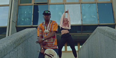 a man and a woman are standing on steps in front of a building