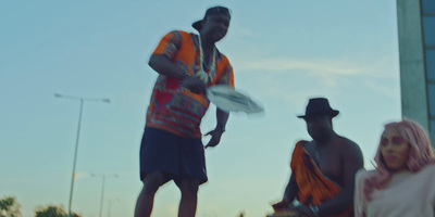 a man is holding a frisbee while a woman is standing next to him