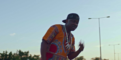 a man in a colorful shirt is standing on a street