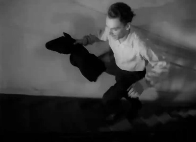 a young boy riding a skateboard on top of a wooden floor