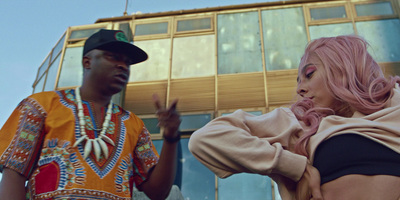 a man standing next to a woman in front of a building