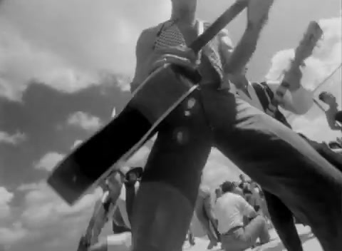 a black and white photo of a man holding a guitar