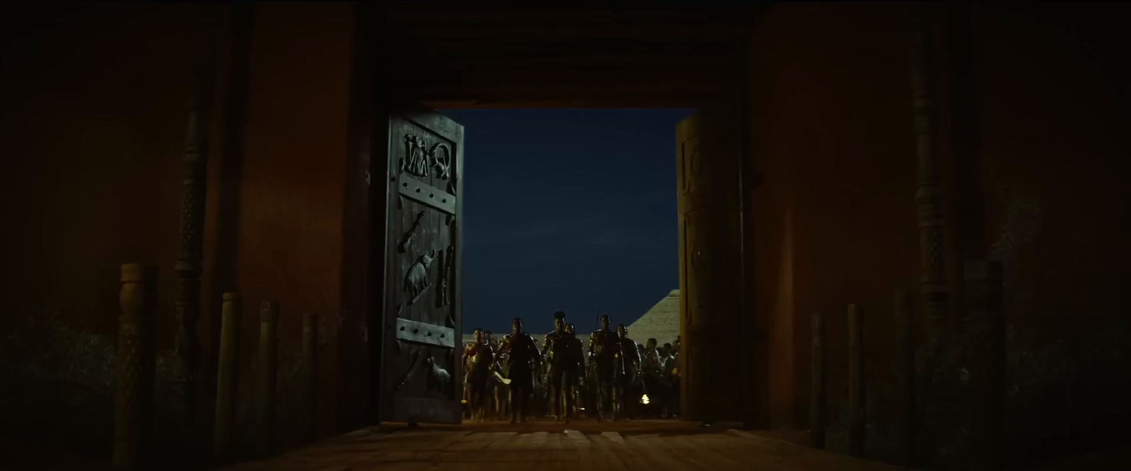 a group of people standing in a doorway at night