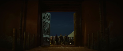 a group of people standing in a doorway at night