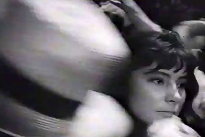 a black and white photo of a woman with a hair dryer