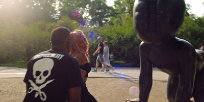 a man and a woman standing next to a statue