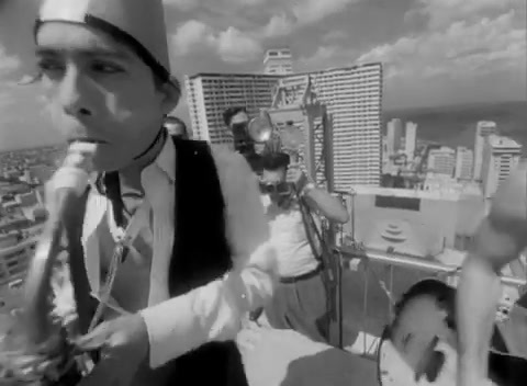 a black and white photo of a man on a rooftop