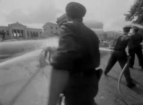 a black and white photo of a fire hydrant spraying water