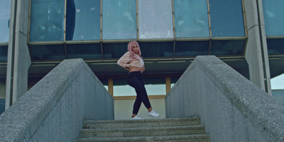 a woman is standing on stairs in front of a building